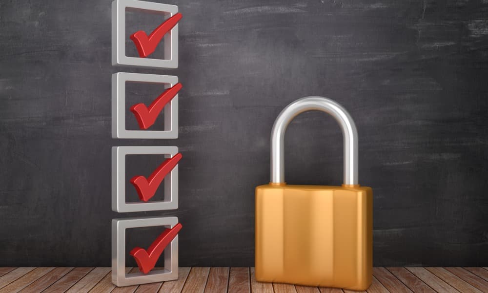 The image displays a wooden table with a gold padlock and a 3-D set of boxes with red checkmarks in them.