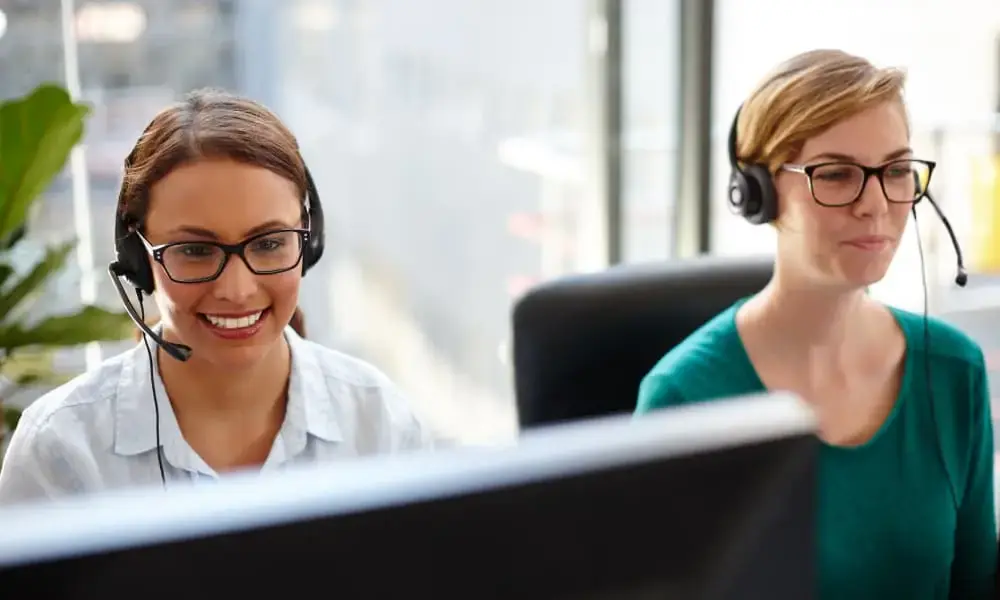 Workers using VoIP for business on computer