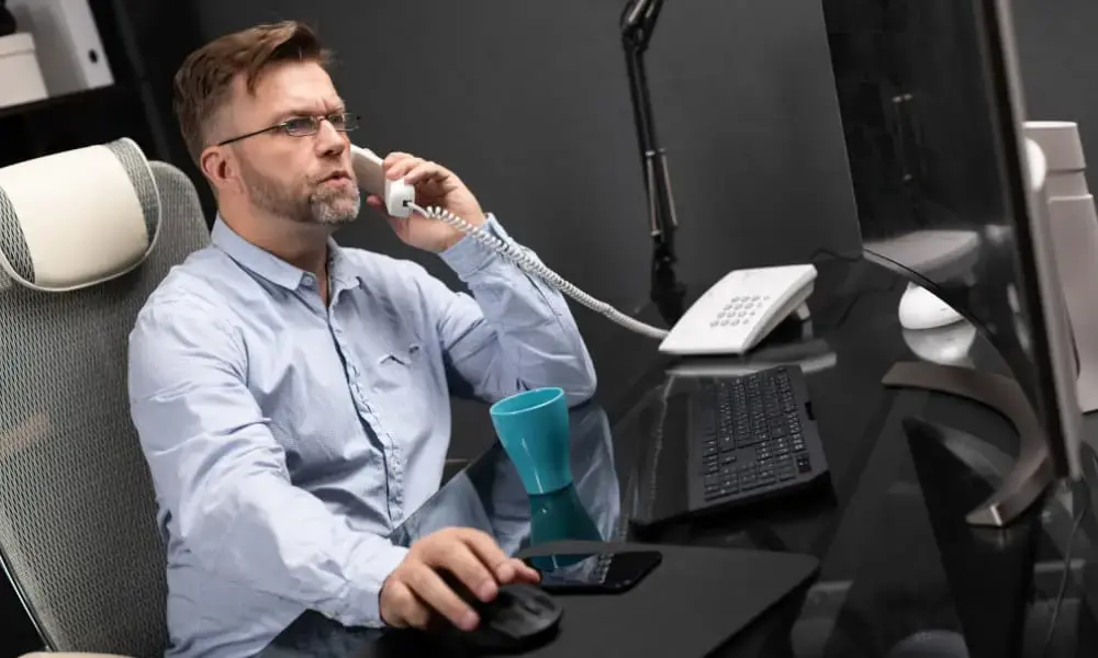 IT professional implementing VoIP security measures to protect business communications and prevent VoIP cyber-attacks.