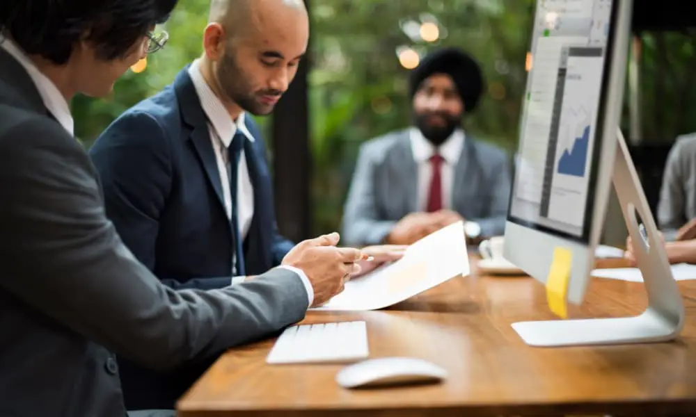 Business owner in a meeting with two Seattle I.T. services representatives.