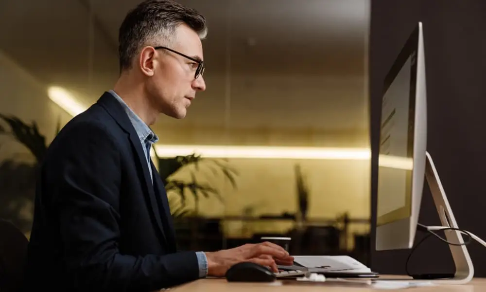 Business executive reviewing performance metrics while evaluating whether to replace their managed services in Seattle.