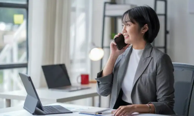 An employee unknowingly talking with a fraudster on the phone.